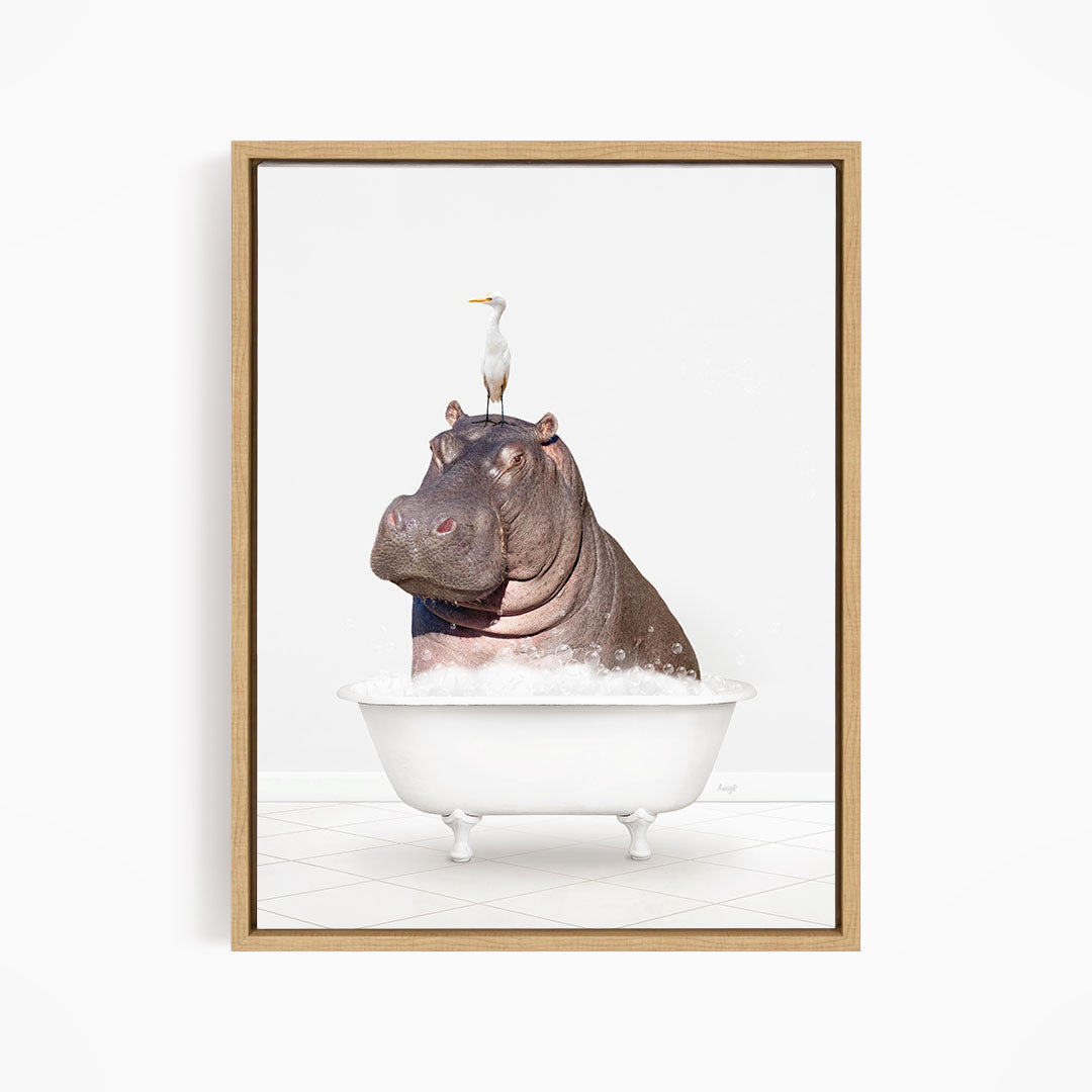 A large hippopotamus is sitting in a white bathtub, with a seagull perched on its head.