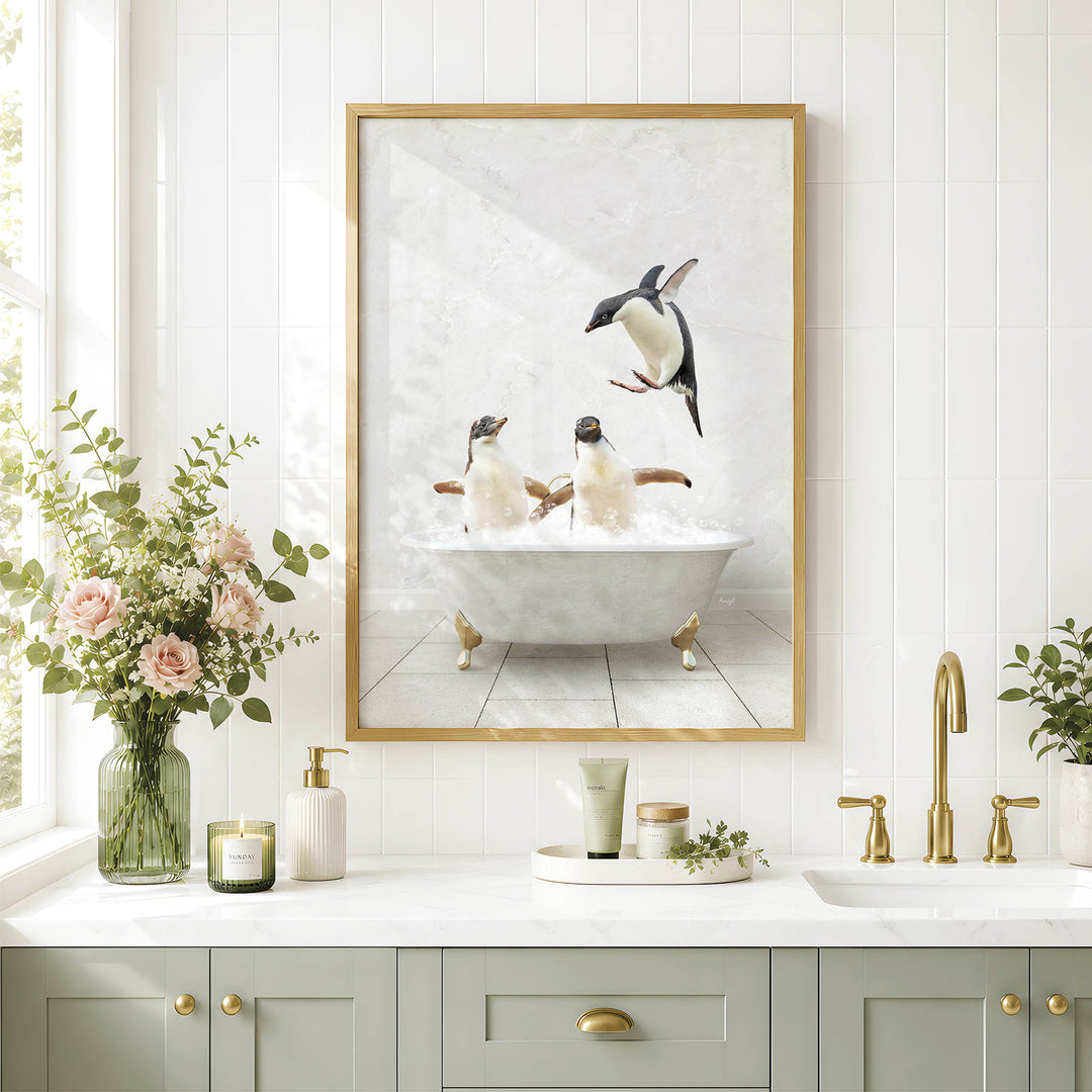 a bathroom scene with a framed picture of penguins sitting in a bathtub, surrounded by flowers and greenery.
