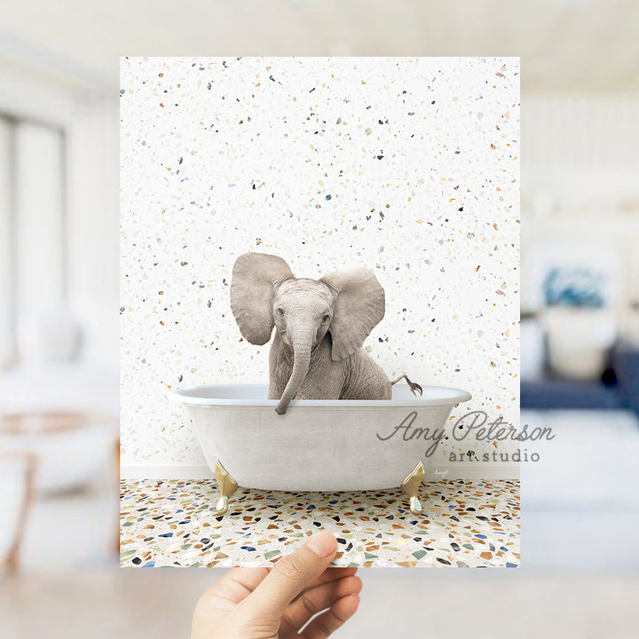 a hand holding up a card with an elephant in a bathtub