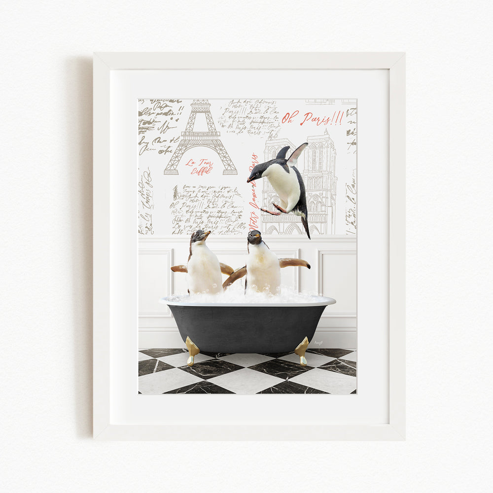 A framed image depicting two penguins sitting in a bathtub, with one penguin standing on the edge of the tub.