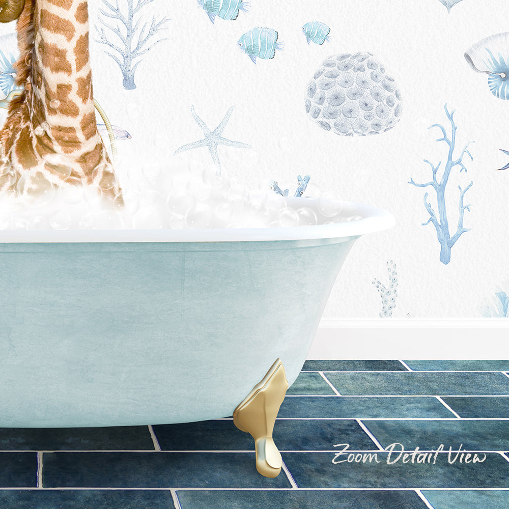 A giraffe standing in a bathtub filled with bubbles, with a blue and white ocean-themed wallpaper in the background.