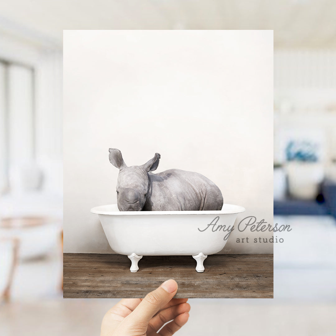 a rhinoceros sitting in a bathtub in a living room