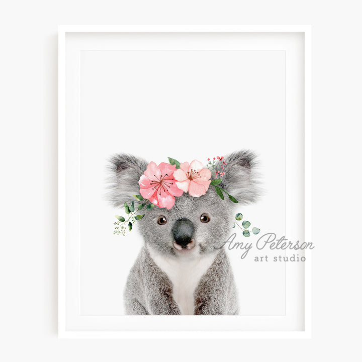 a picture of a koala with flowers on its head