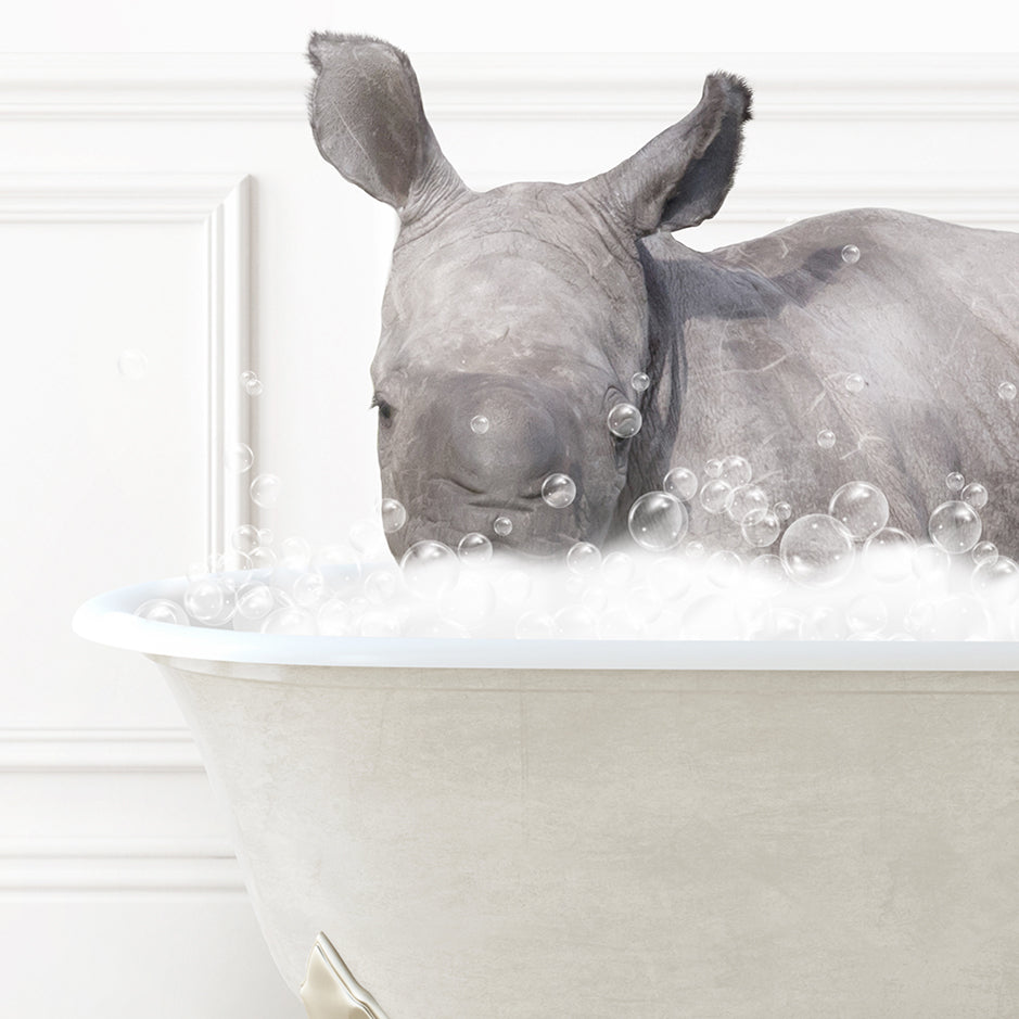 a rhino laying in a bathtub filled with bubbles