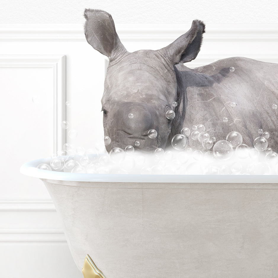 a rhino laying in a bathtub filled with bubbles