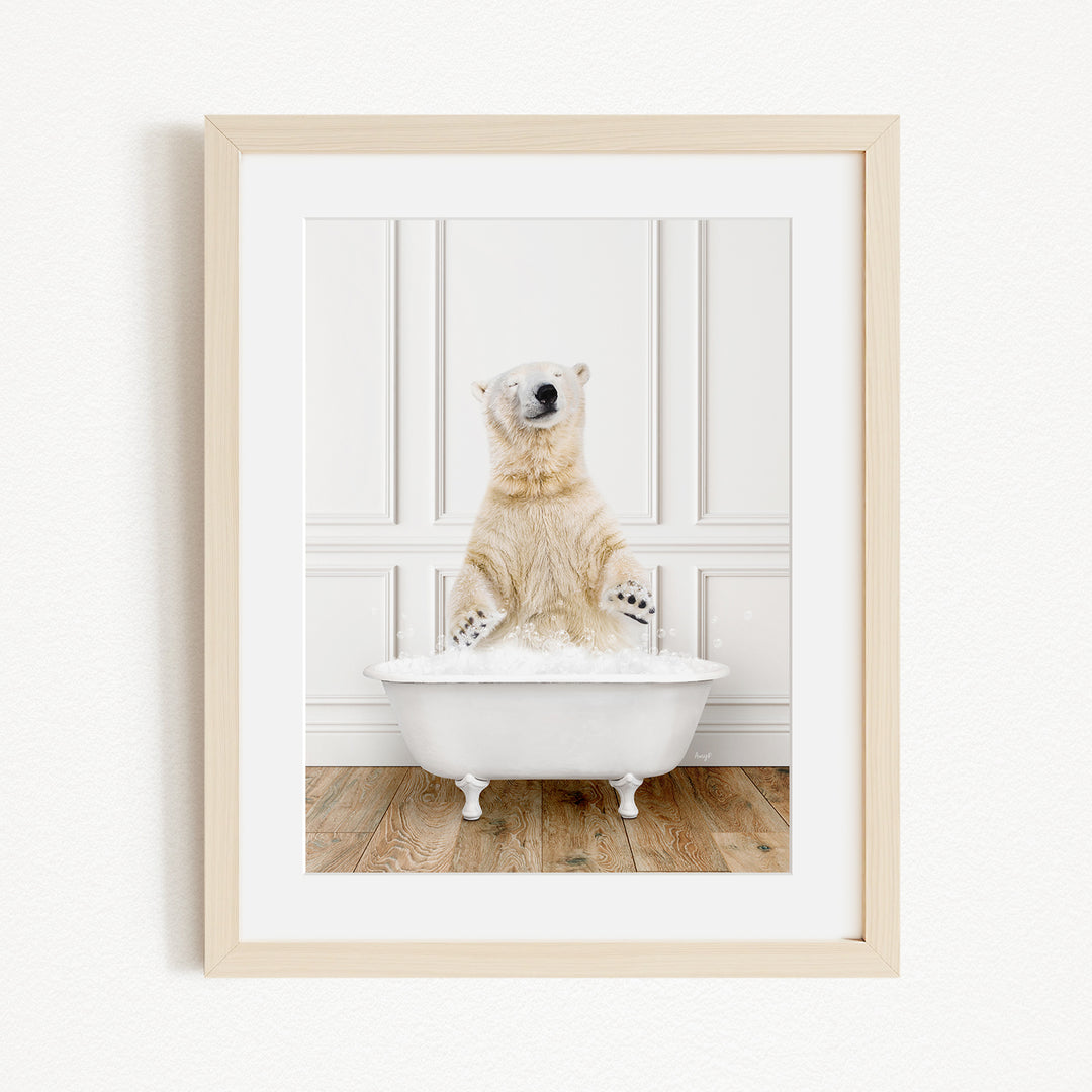 A polar bear sitting in a white bathtub filled with water, appearing to enjoy the bath.