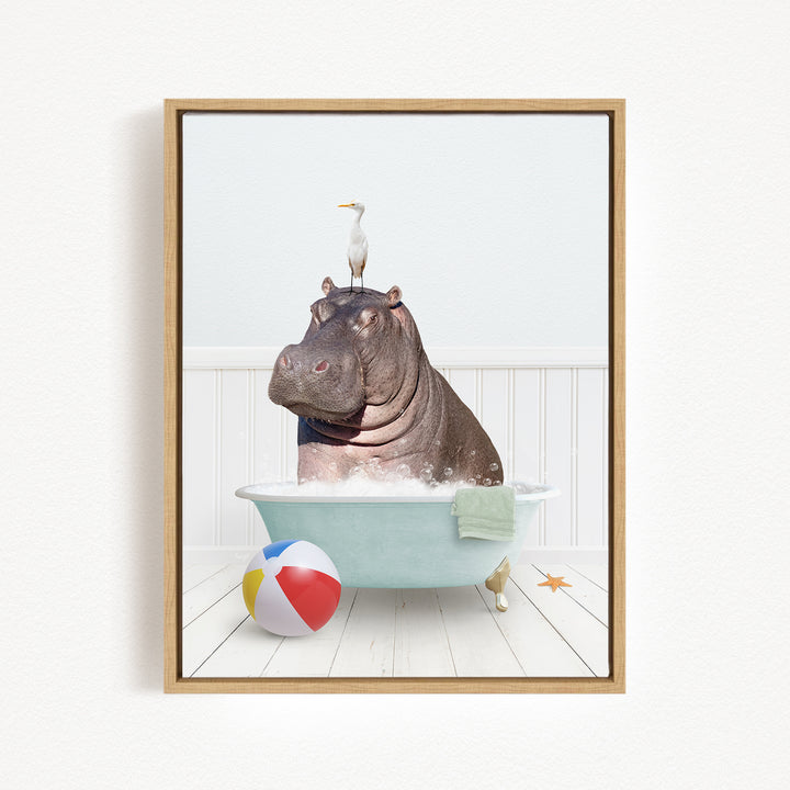 A hippopotamus sitting in a bathtub, with a bird perched on its head, and a beach ball nearby.