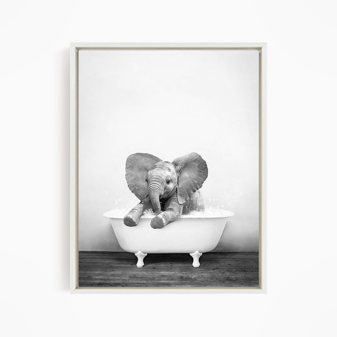 A baby elephant sitting in a bathtub filled with water, enjoying a bath.