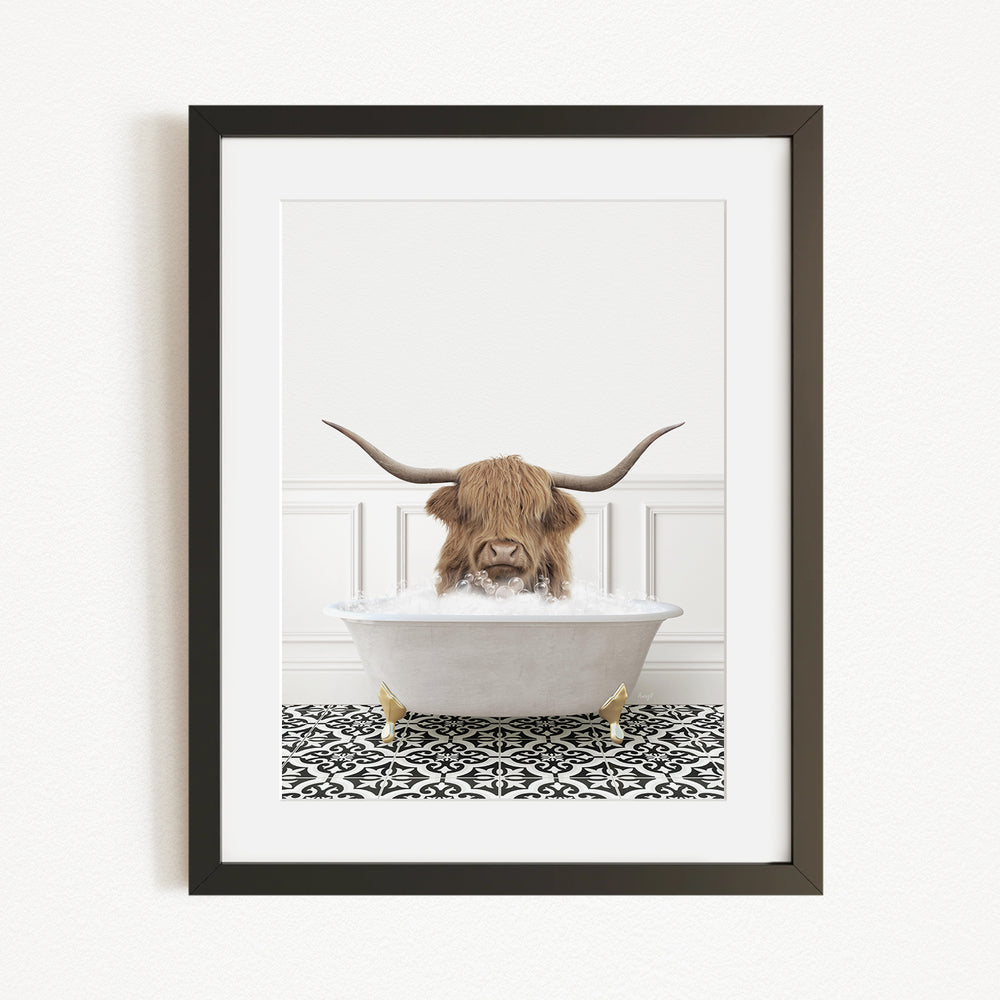 A framed image depicting a horned animal, likely a yak or a similar animal, sitting in a white bathtub filled with water, creating a whimsical and playful scene.