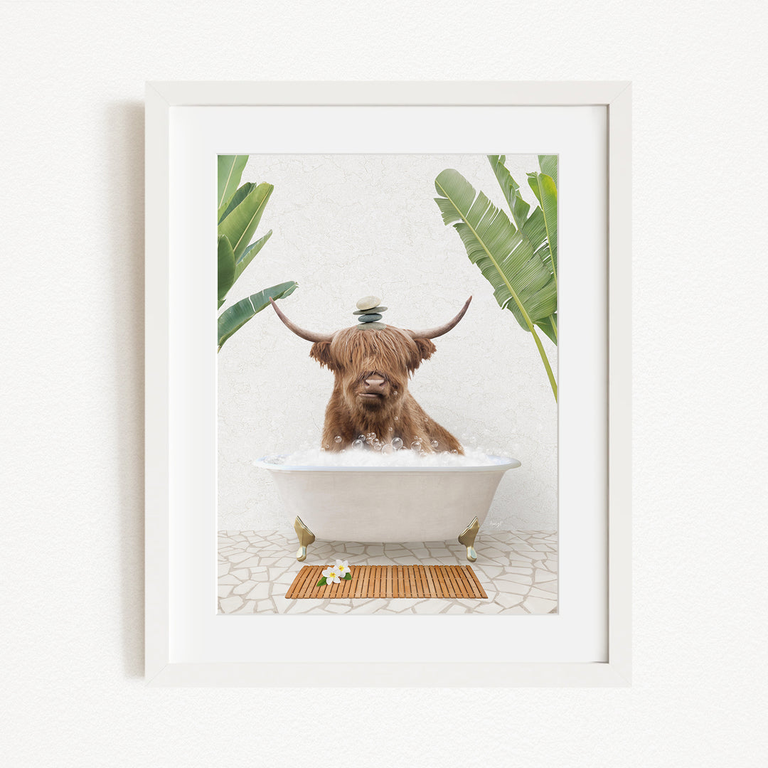 A brown cow with horns is sitting in a white bathtub filled with water, surrounded by green plants and a wooden mat on the floor.