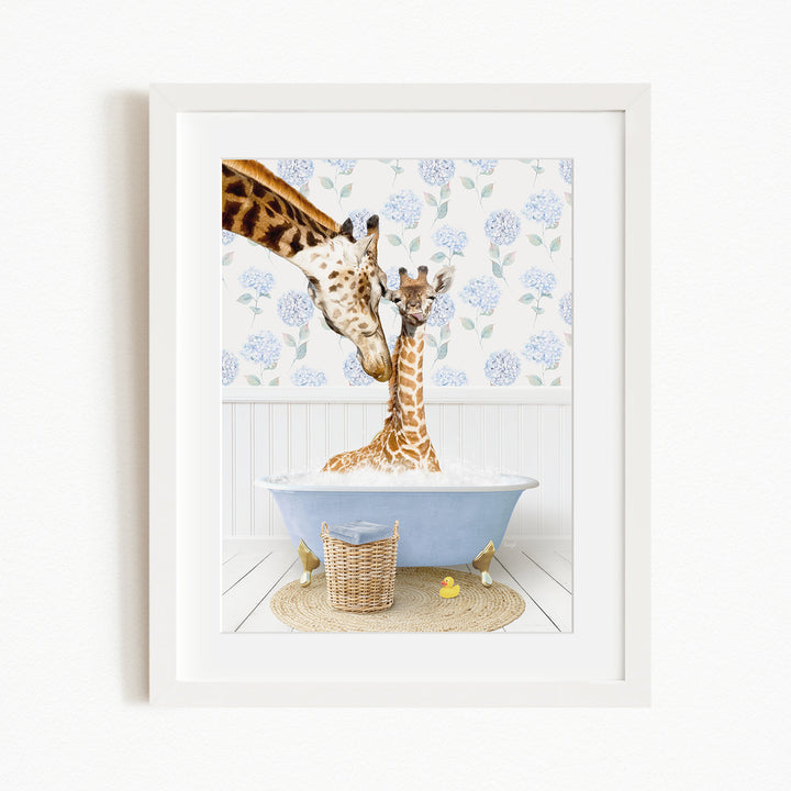 A giraffe and a baby giraffe are sitting in a blue bathtub filled with water, surrounded by a white floral patterned wall and a basket of rubber ducks.