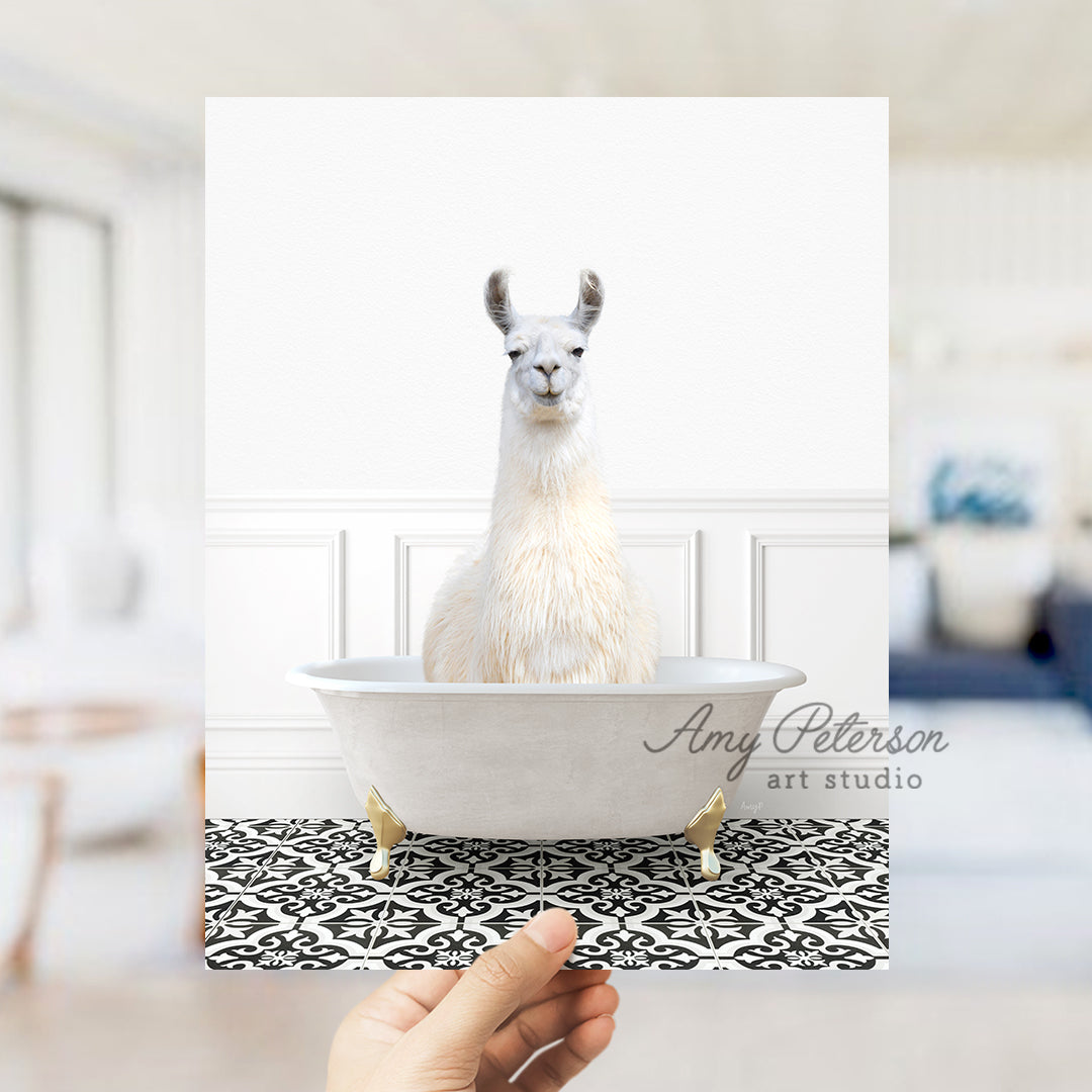 a llama sitting in a bathtub with a hand holding it