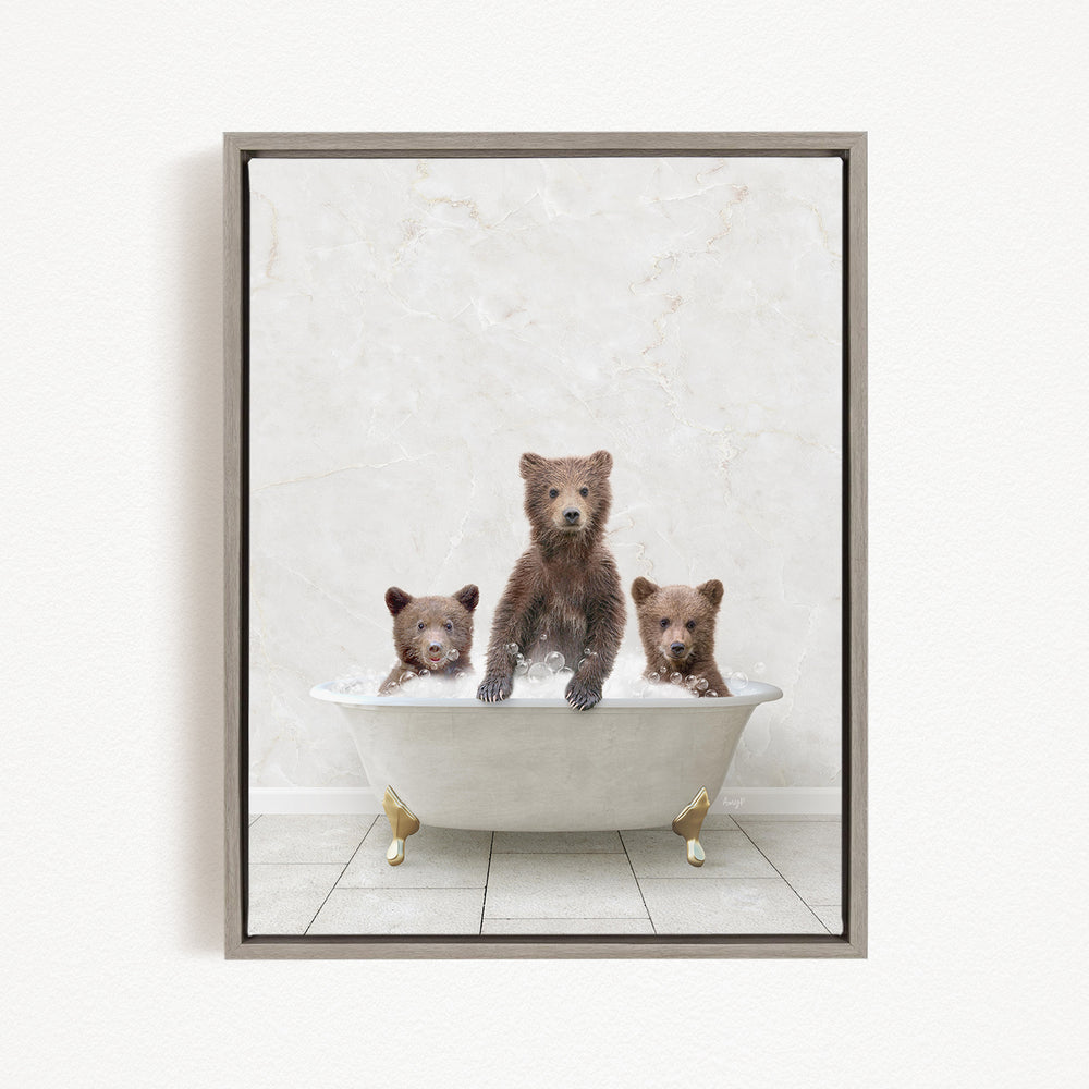 A framed image depicting three brown bears sitting in a white bathtub, with one bear sitting at the center and the other two bears sitting on either side.