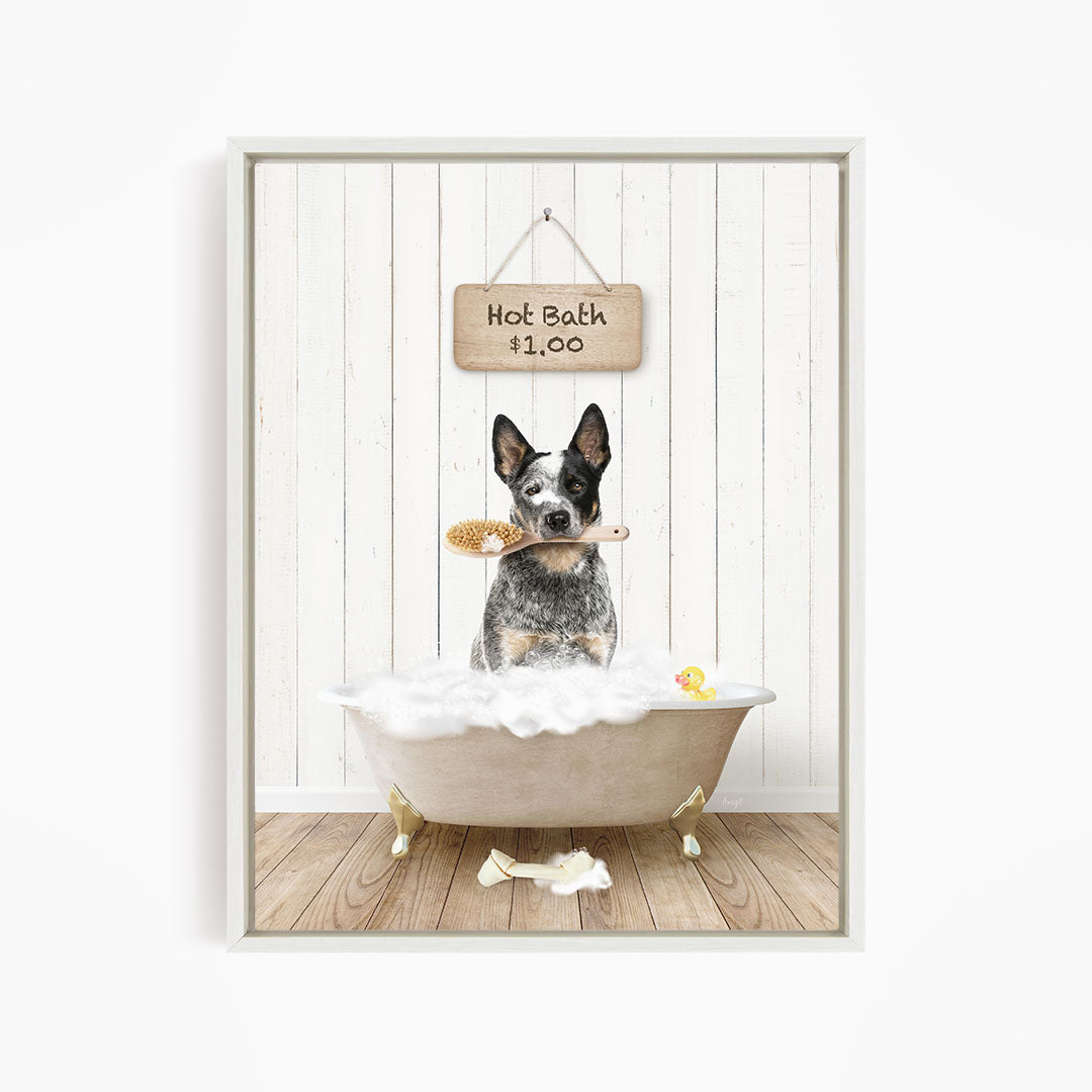 A black and white dog sitting in a white bathtub, holding a brush in its mouth, with a sign above the bathtub that reads "Hot Bath $1.00".