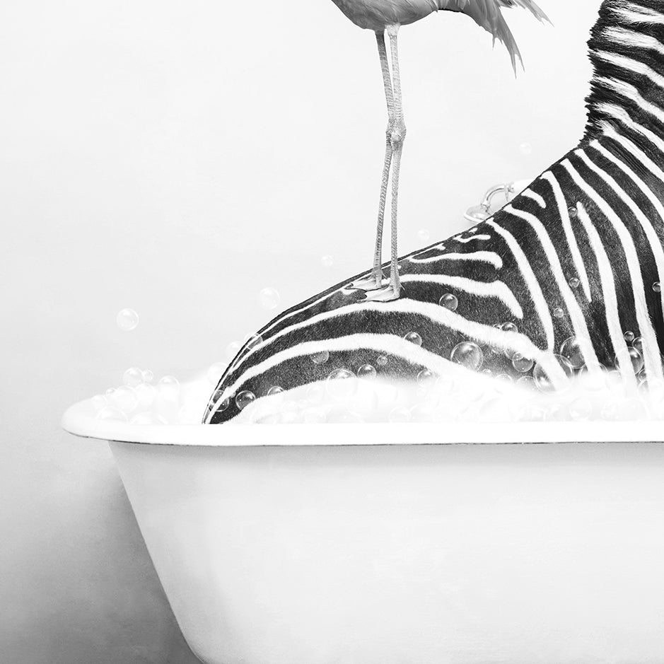 a bird standing on top of a zebra in a bathtub