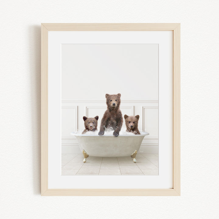A framed image of three bears sitting in a bathtub, with one bear sitting in the center and the other two bears sitting on either side.