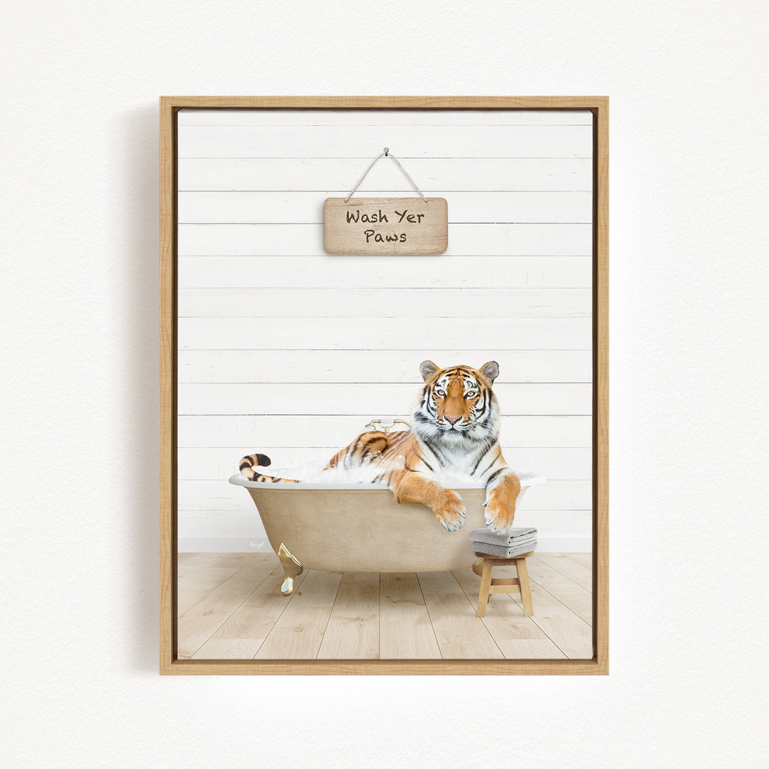 A tiger is sitting in a bathtub, with a sign above it that says "Wash Your Paws".