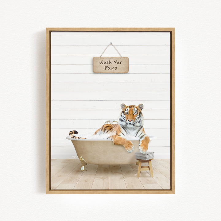 A tiger is sitting in a bathtub, with a sign above it that says "Wash Your Paws".