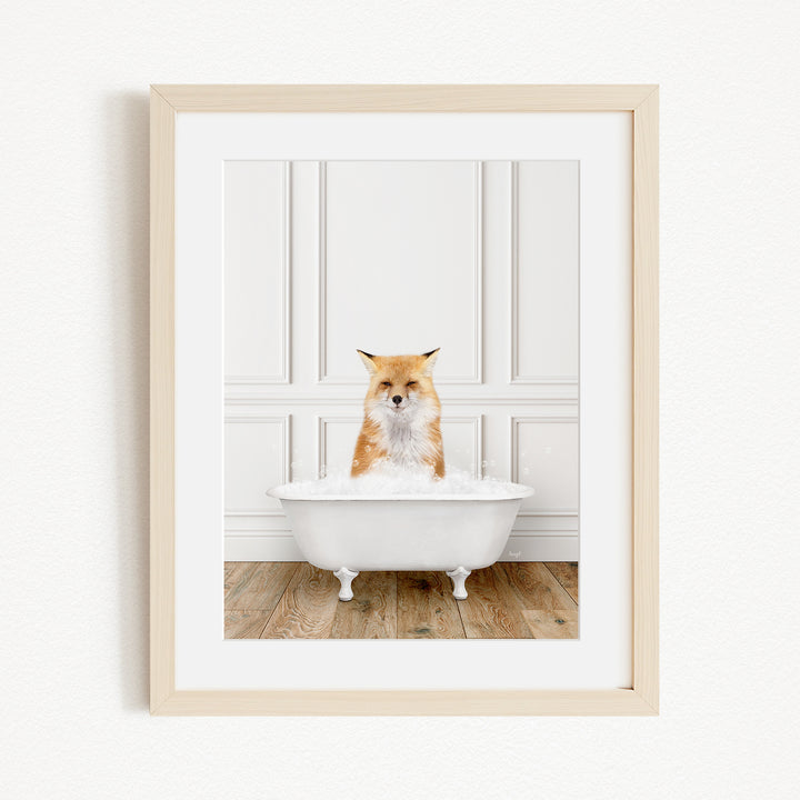 A red fox is sitting in a white bathtub filled with bubbles, creating a whimsical and playful scene.