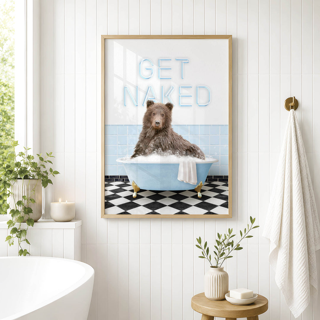 a framed poster with a bear sitting in a bathtub, surrounded by a checkered floor and a towel.