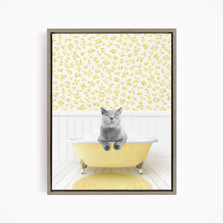 A gray cat sitting in a yellow bathtub, surrounded by a yellow floral pattern on the walls.