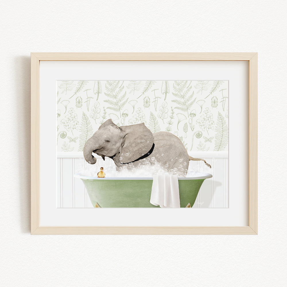 A framed image depicting an elephant sitting in a green bathtub, with a person standing next to it.