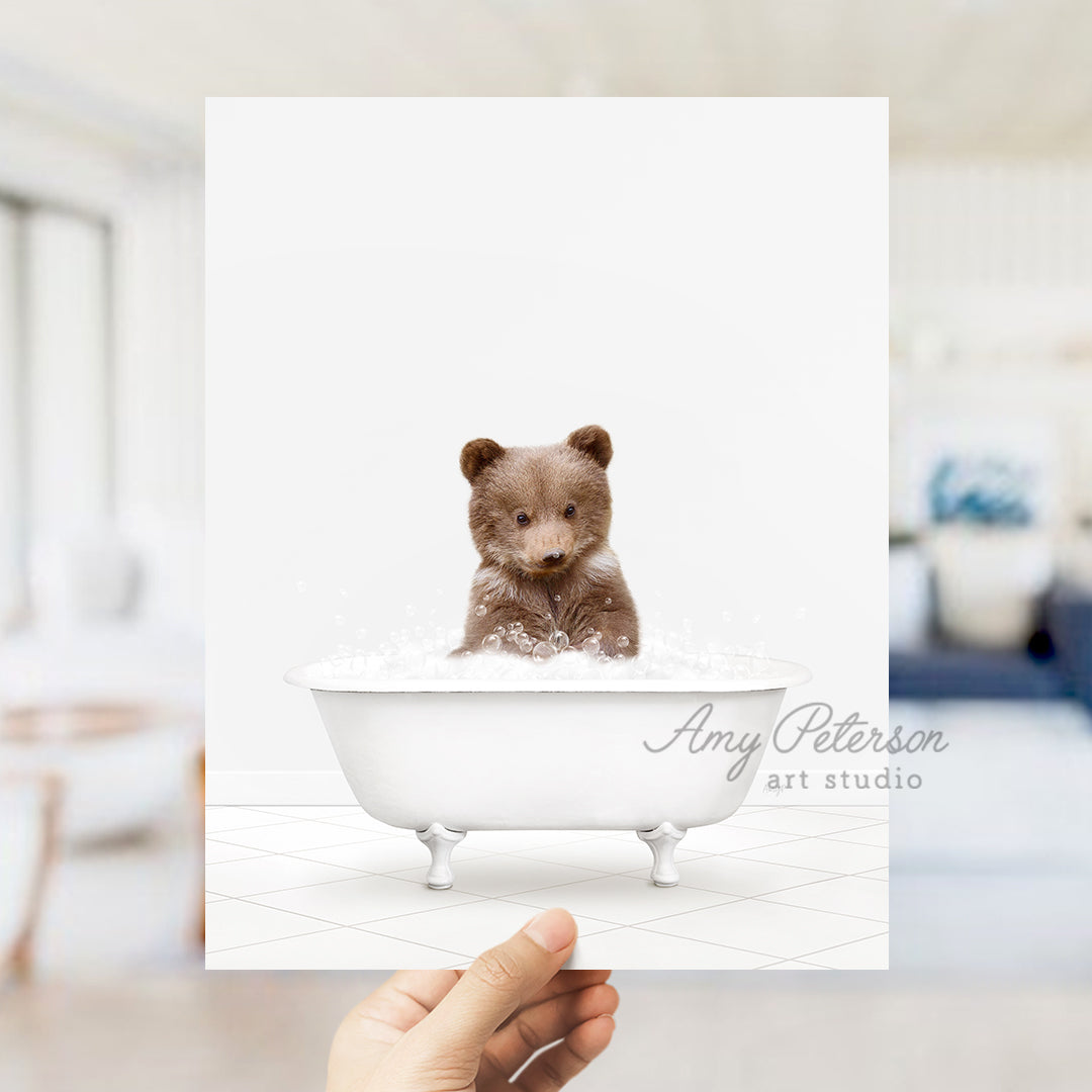 a person holding a card with a picture of a teddy bear in a bathtub