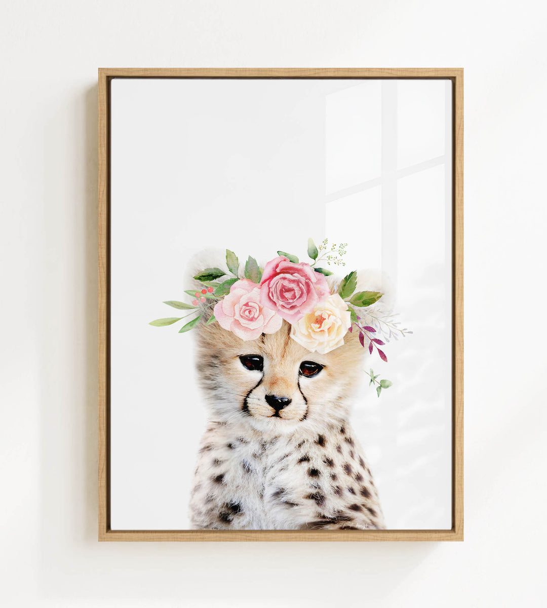 A cheetah wearing a floral crown of pink and white flowers.