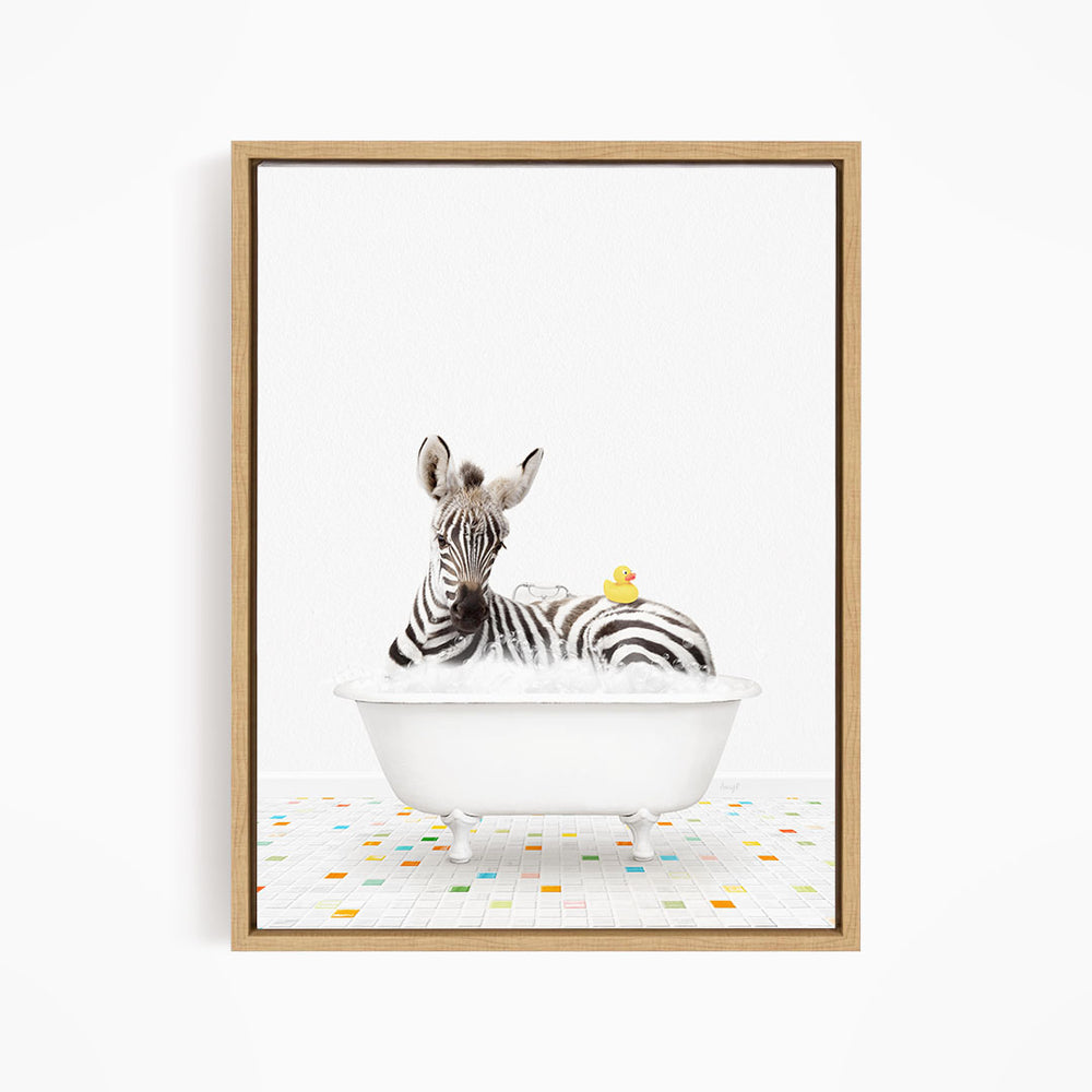 A zebra is sitting in a white bathtub, surrounded by a yellow rubber duck.