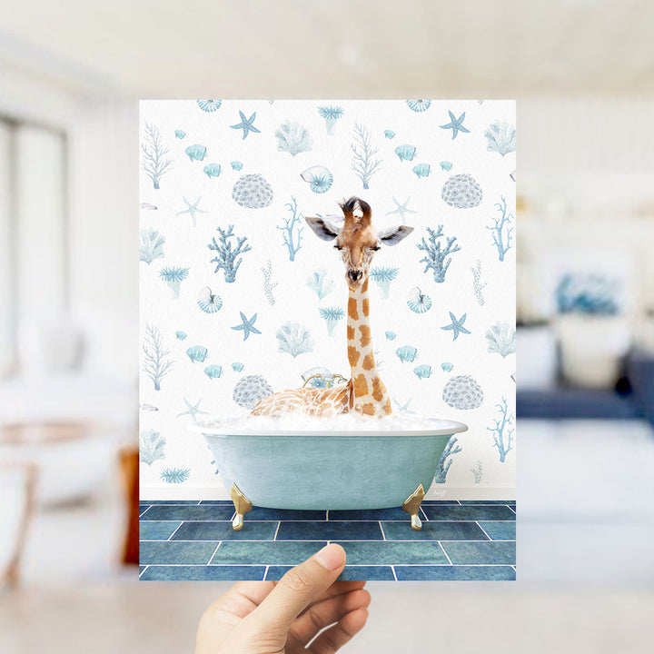 A giraffe sitting in a bathtub filled with bubbles, surrounded by a blue and white ocean-themed wallpaper.