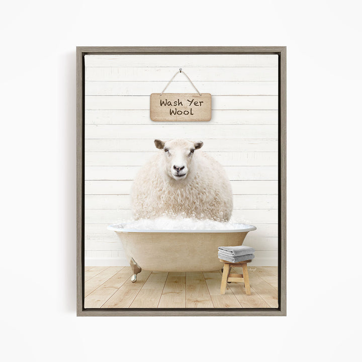 A fluffy white sheep is sitting in a bathtub filled with water, with a wooden sign above it that says "Wash Yer Wool".