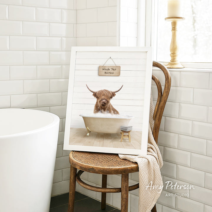 A framed image of a Highland cow sitting in a bathtub, with a sign above it that says "Wish You Happy Holidays".