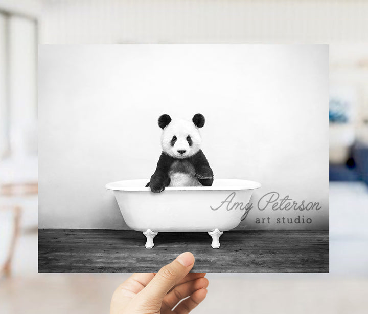 a panda bear sitting in a bath tub