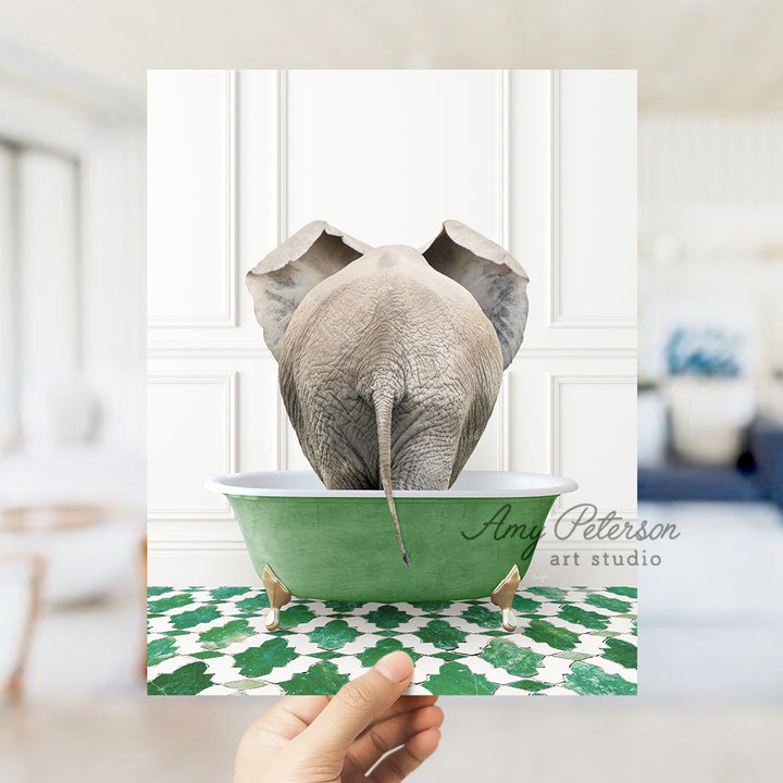 a hand holding a card with an elephant in a bathtub