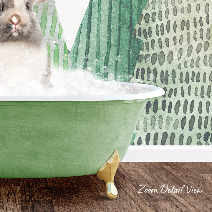 A small rabbit is sitting in a green bathtub filled with bubbles, with a patterned wall in the background.