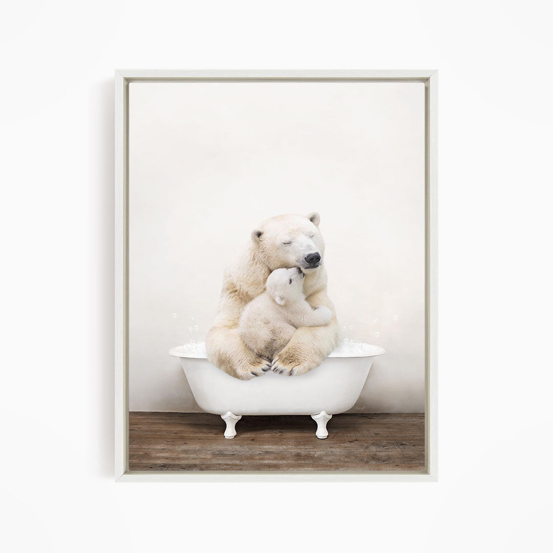 A mother polar bear tenderly embracing her cub in a white bathtub against a plain white background.