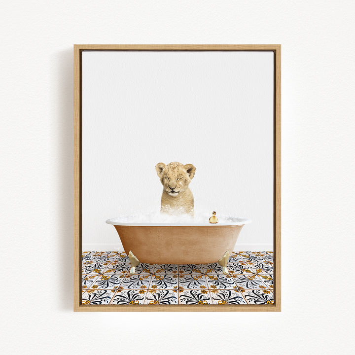 A young lion cub sitting in a bathtub filled with bubbles, surrounded by a patterned tile floor.