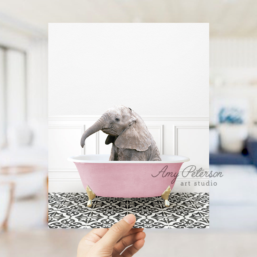 a person holding up a card with a picture of an elephant in a bathtub