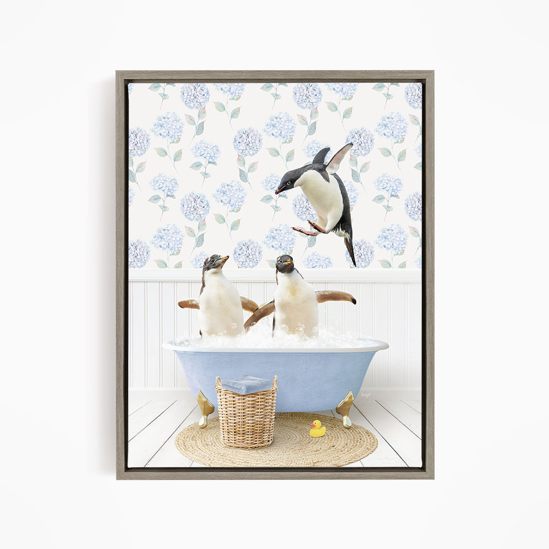 A framed image depicting two penguins sitting in a bathtub filled with bubbles, with one penguin flying towards the other.