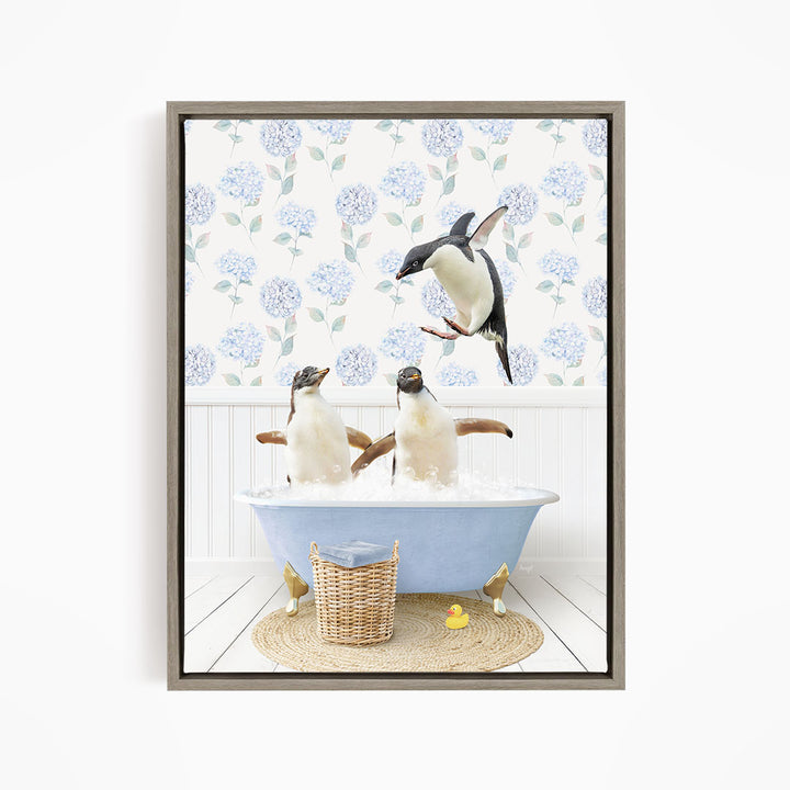A framed image depicting two penguins sitting in a bathtub filled with bubbles, with one penguin flying towards the other.