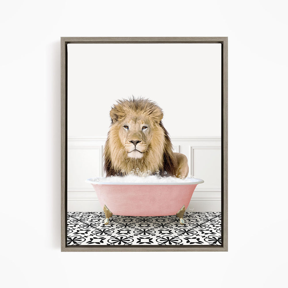 A lion sitting in a pink bathtub filled with bubbles, looking directly at the camera.
