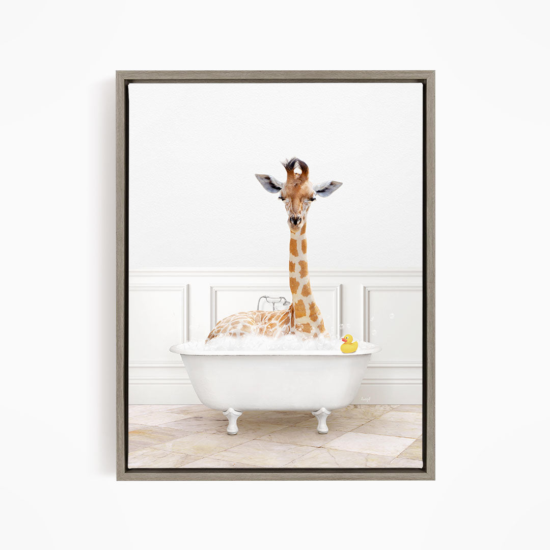 A giraffe is sitting in a white bathtub filled with water, surrounded by a yellow rubber duck.