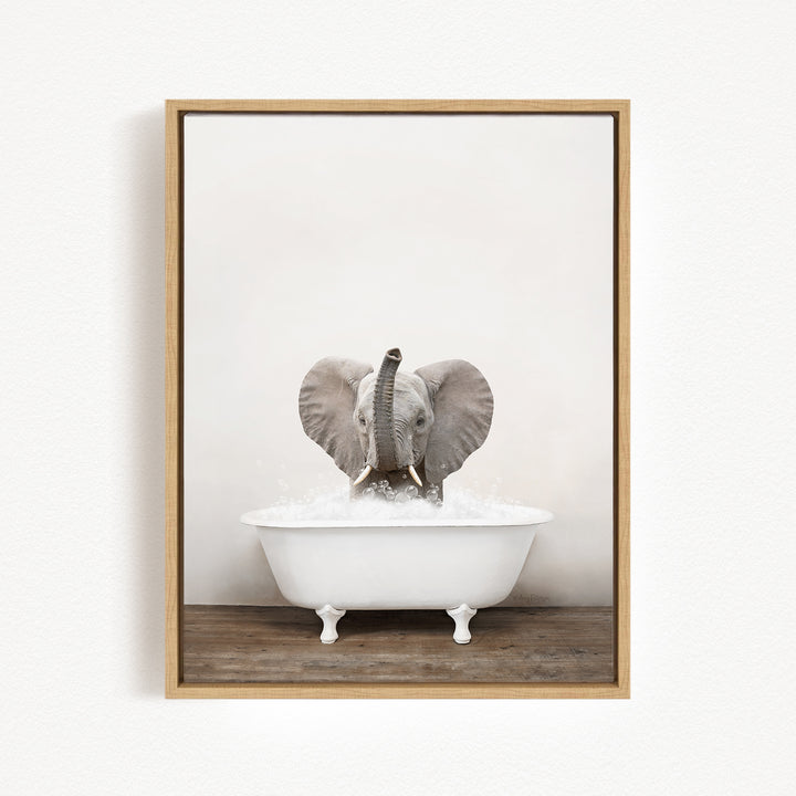 A baby elephant sitting in a white bathtub filled with water, with its trunk raised in the air.