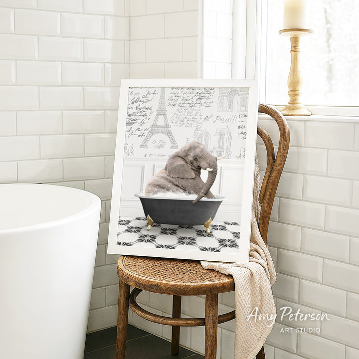 A framed image of a cat sitting in a bathtub, surrounded by a tiled bathroom setting.