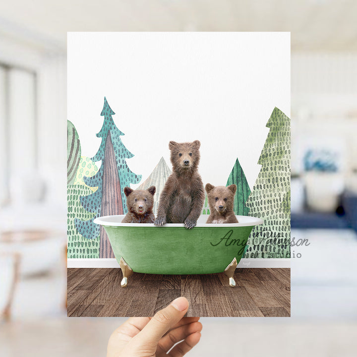 a person holding up a card with three bears in a bathtub