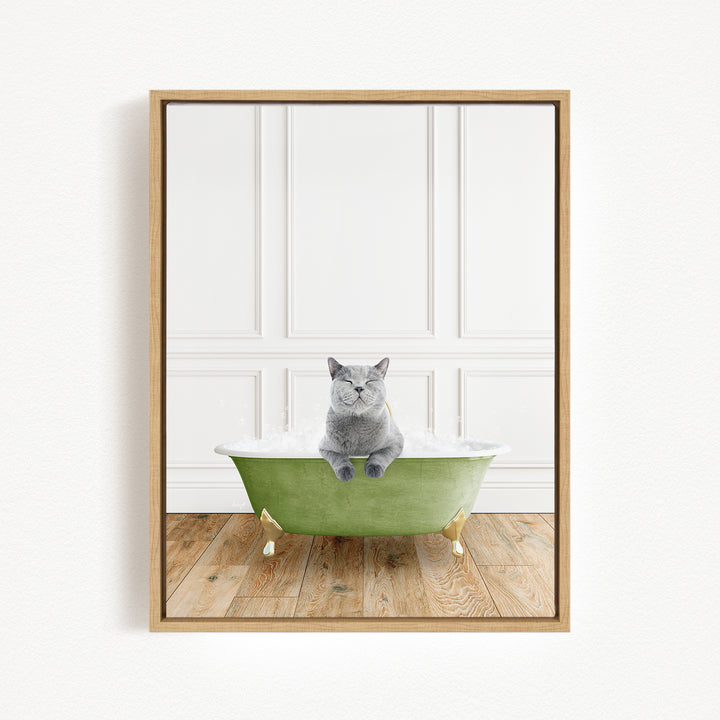 A gray cat sitting in a green bathtub, with a white wall and wooden floor in the background.