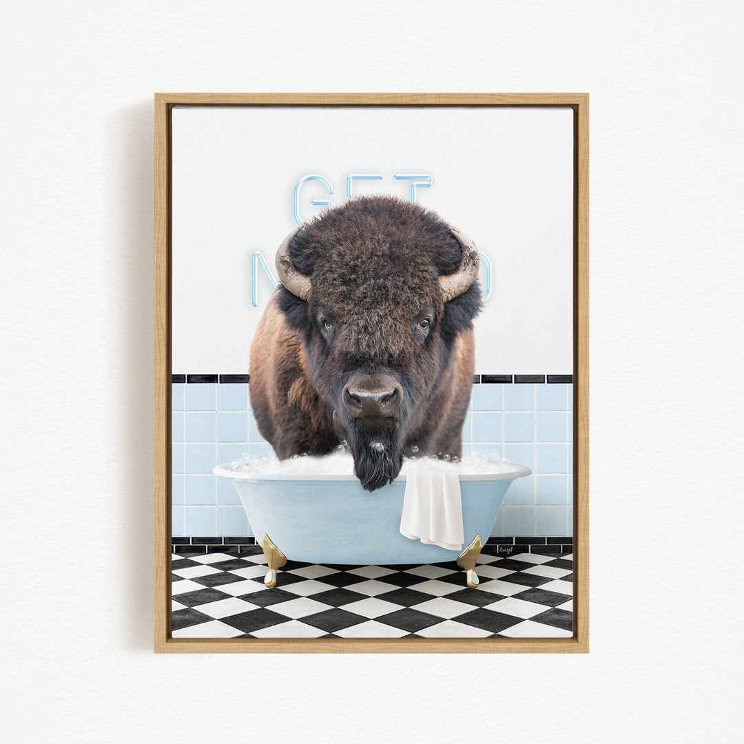 A buffalo is sitting in a bathtub filled with water, with a towel hanging on the side of the tub.