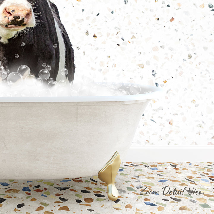 A cow standing in a bathtub filled with bubbles, with a mosaic floor in the foreground.