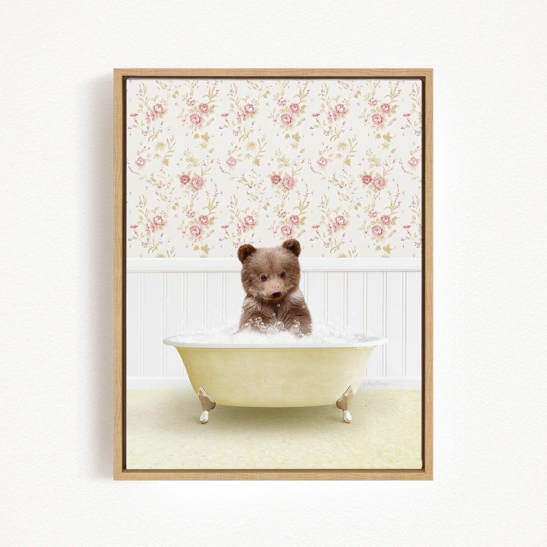 A brown bear sitting in a white bathtub filled with water, surrounded by a floral wallpaper.