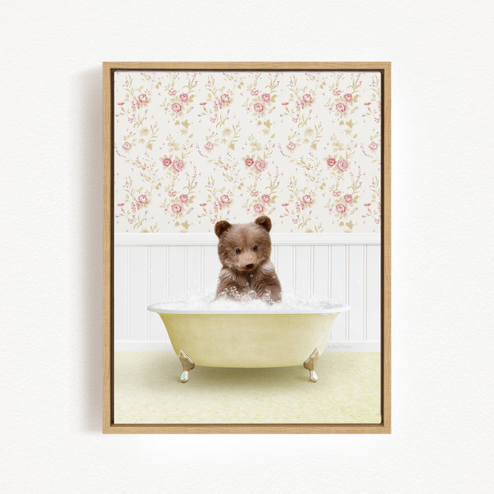 A brown bear sitting in a white bathtub filled with water, surrounded by a floral wallpaper.